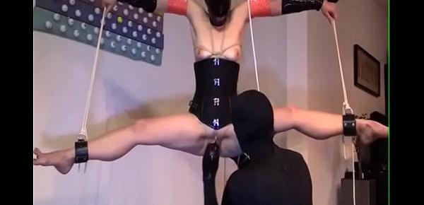  Restrained, bound, legs spread & suspended from ceiling. Masked vagina fisting.